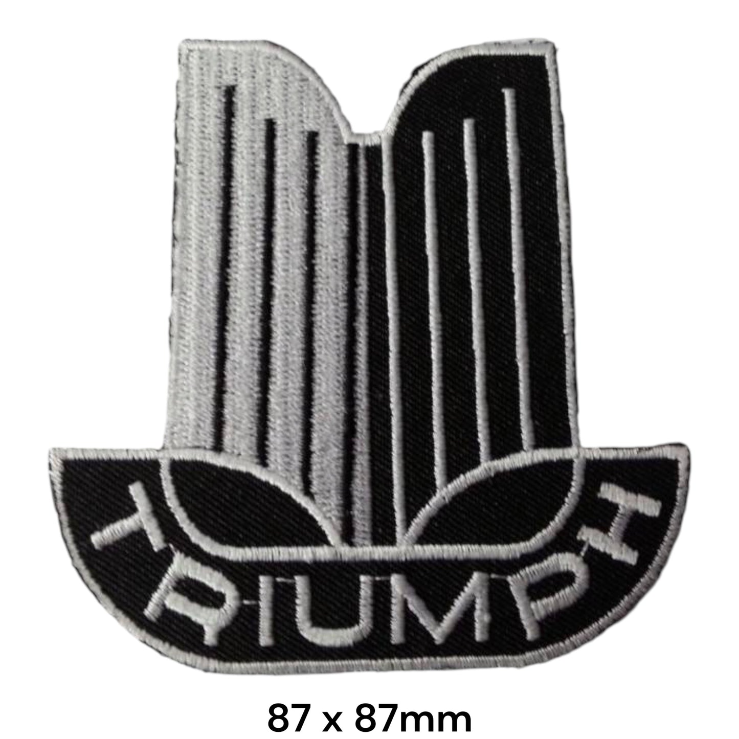 Triumph Classic Eagle Crest Embroidered Patch 87x87mm – silver & black classic Triumph crest with eagle/wing motif, vertical pin-stripe detail and white Triumph block lettering on black semicircular base