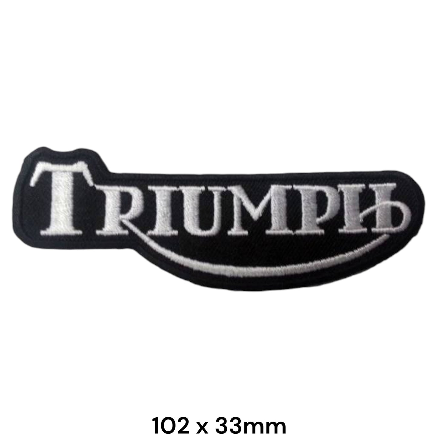 Triumph Silver Tank Badge Embroidered Patch 102x33mm – shaped black tank-badge silhouette with bold silver-white Triumph serif lettering, silver swoosh underline and silver border