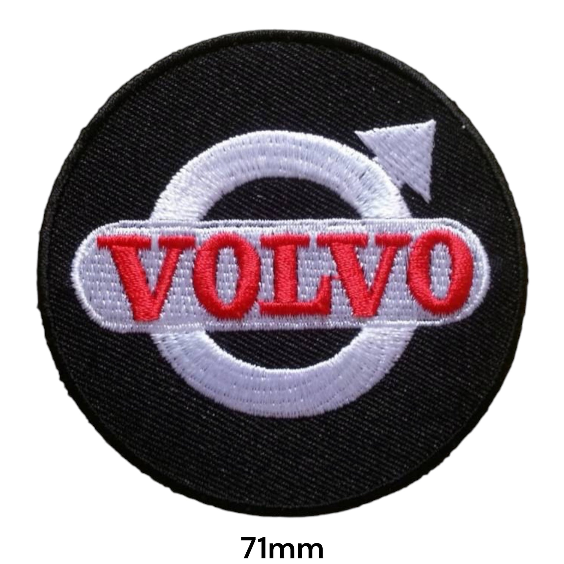 Volvo Iron Mark Round Embroidered Patch 71mm – round black badge with silver iron mark circle & arrow symbol and white banner with bold red Volvo block lettering